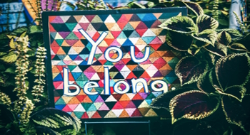Colourful wall with 'you belong' written on it;